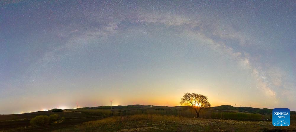 This stitched photo taken on May 10, 2026 shows the Milky Way and the moon above Shuangyashan, northeast China's Heilongjiang Province. (Photo by Han Yang/Xinhua)