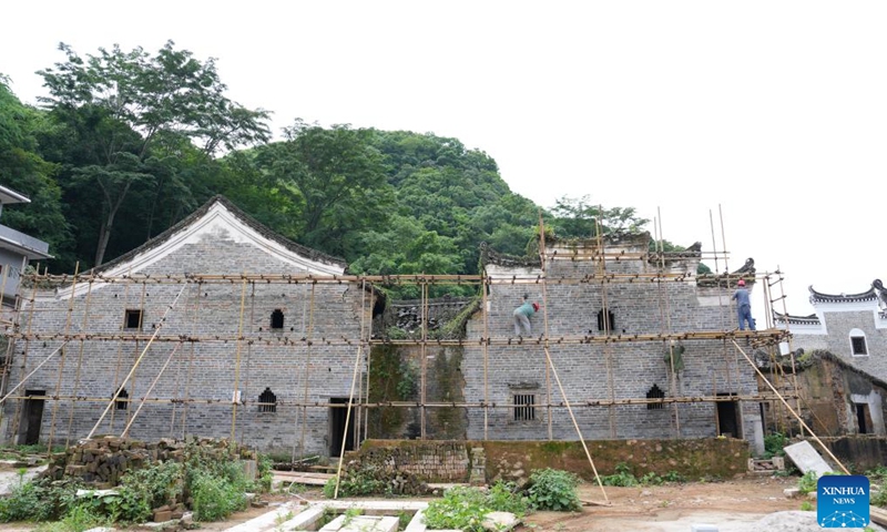 Workers repair an ancient residence in Baojing Village of Yongzhou, central China's Hunan Province, May 10, 2026. Nestled amid the mountains of Jianghua Yao Autonomous County in Yongzhou, Baojing Village was built by the ancestors of the He family in 1650, and is therefore called the Courtyard of Family He. There are 180 existing ancient residences, 7 gate towers and 36 alleys.
