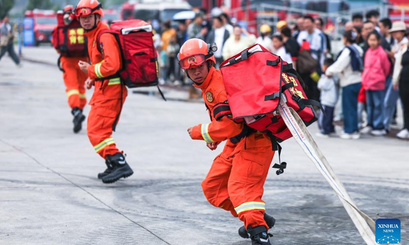 Firefighters participate in a fire-extinguishing demonstration during a public safety awareness event marking the National Disaster Prevention and Mitigation Day at a rescue base in Guiyang, southwest China's Guizhou Province, May 10, 2026. (Xinhua/Yang Wenbin)

