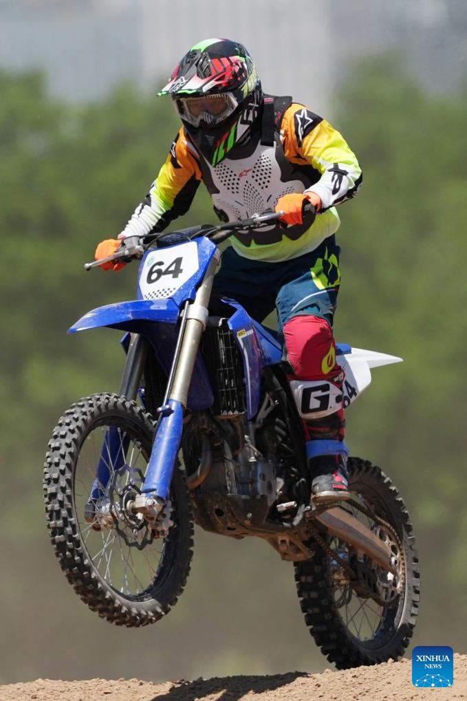 Zhang Xue, founder of Chinese motorcycle manufacturer ZXMOTO, is seen during a motocross league event held in the Xixian New Area of northwest China's Shaanxi Province, May 4, 2026. (Xinhua/Li Yibo)

