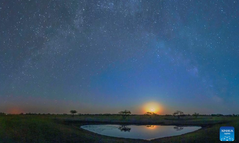 This stitched photo taken on May 10, 2026 shows the Milky Way and the moon above Daqing City, northeast China's Heilongjiang Province. (Photo by Wang Yonggang/Xinhua)