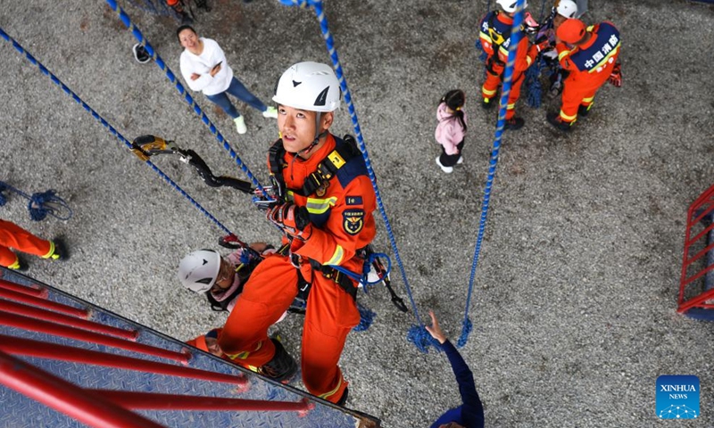 Firefighters demonstrate rope rescue during a public safety awareness event marking the National Disaster Prevention and Mitigation Day at a rescue base in Guiyang, southwest China's Guizhou Province, May 10, 2026. (Xinhua/Yang Wenbin)

