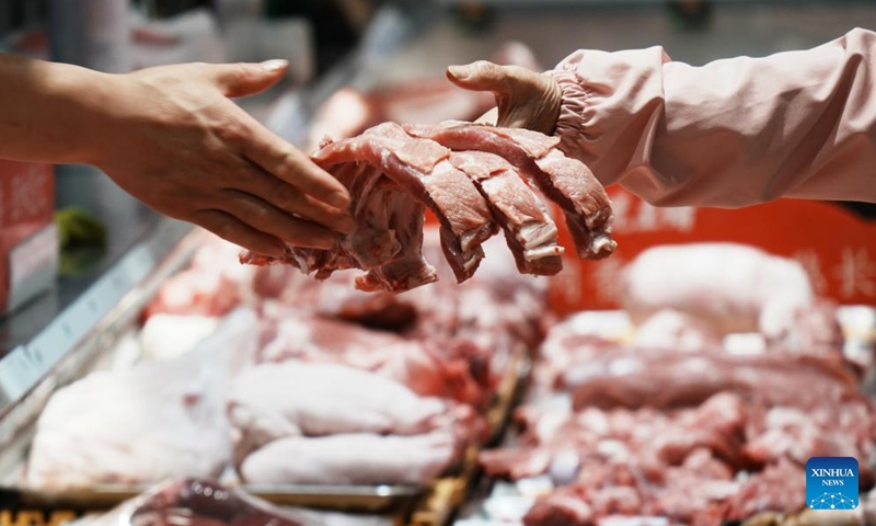 A customer buys pork at a supermarket in Hangzhou City, east China's Zhejiang Province, on May 11, 2026. (Photo by Long Wei/Xinhua)