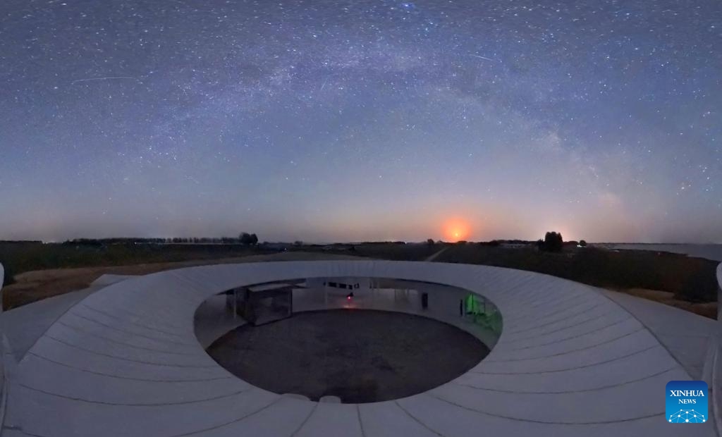 This panoramic photo taken on May 10, 2026 shows the Milky Way and the moon above the Mongolian Autonomous County of Dorbod, Daqing City, northeast China's Heilongjiang Province. (Photo by Liu Dapeng/Xinhua)