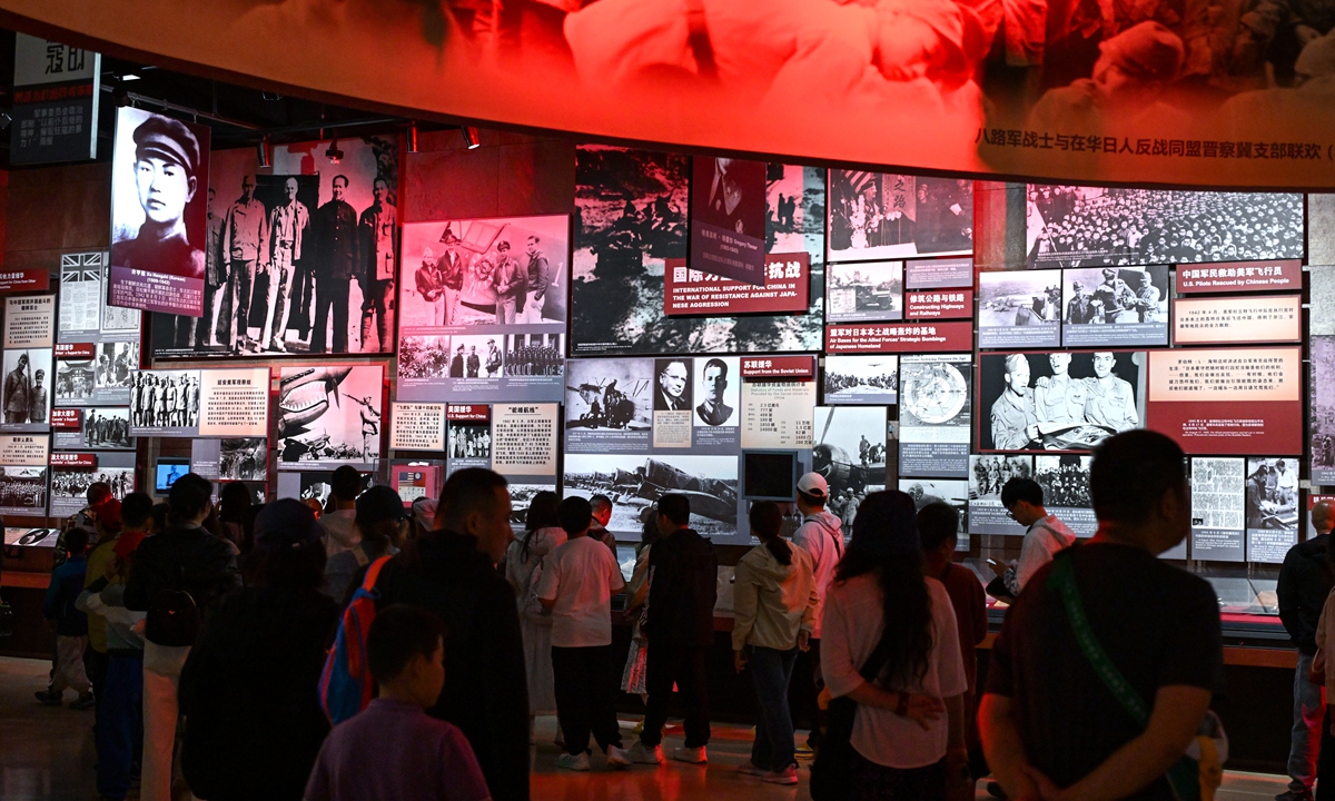 Visitors explore the historical photos related to the Chinese People's War of Resistance Against Japanese Aggression at the Memorial Hall of the Victims of the Nanjing Massacre in Nanjing on May 2, 2025. Photo: VCG