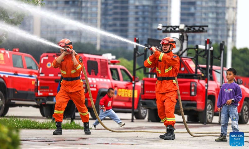 Firefighters demonstrate the use of water guns during a public safety awareness event marking the National Disaster Prevention and Mitigation Day at a rescue base in Guiyang, southwest China's Guizhou Province, May 10, 2026. (Xinhua/Yang Wenbin)

