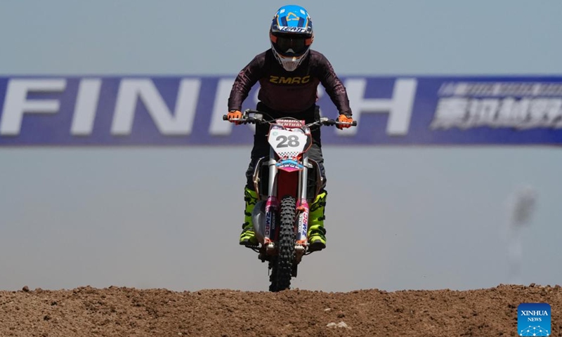 Zhang Jiayu, a racer of Zhang Min Riding Classroom, is seen during a motocross league event held in the Xixian New Area of northwest China's Shaanxi Province, May 4, 2026. (Xinhua/Li Yibo)

