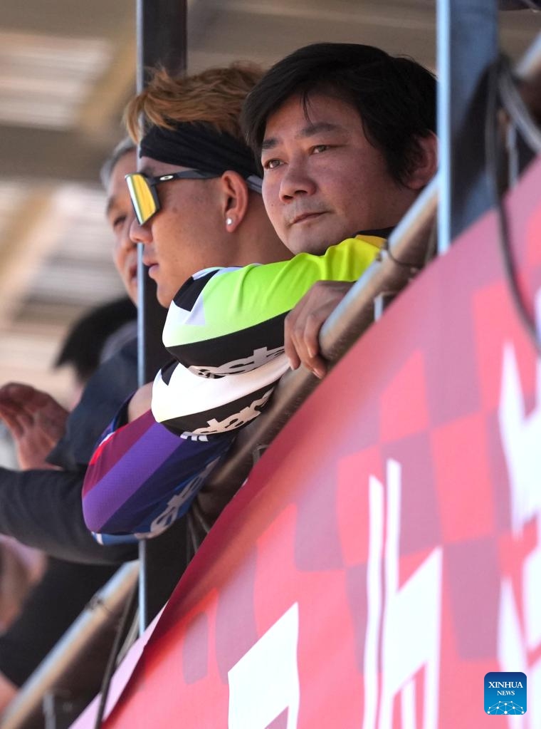 Zhang Xue (R), founder of Chinese motorcycle manufacturer ZXMOTO, watches his son Zhang Qingtian's race during a motocross league event held in the Xixian New Area of northwest China's Shaanxi Province, May 4, 2026. (Xinhua/Li Yibo)

