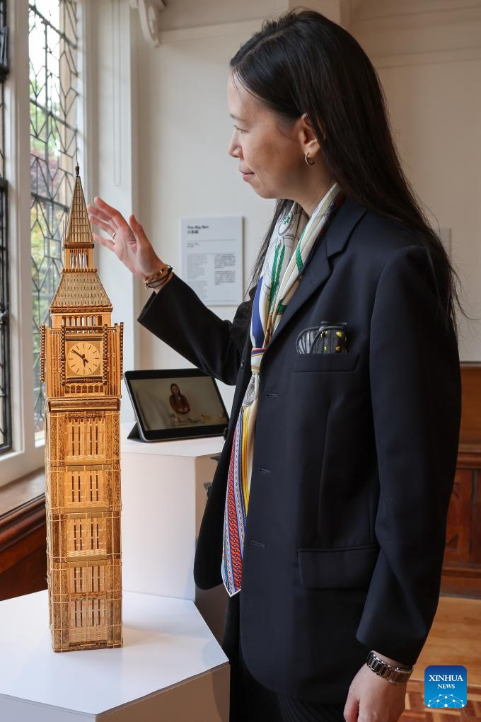 A woman looks at a bamboo-made The Big Ben, a replica of London's iconic clock tower, during London Craft Week, in central London, Britain, May 11, 2026. The event is held here from May 11 to 17. (Xinhua)

