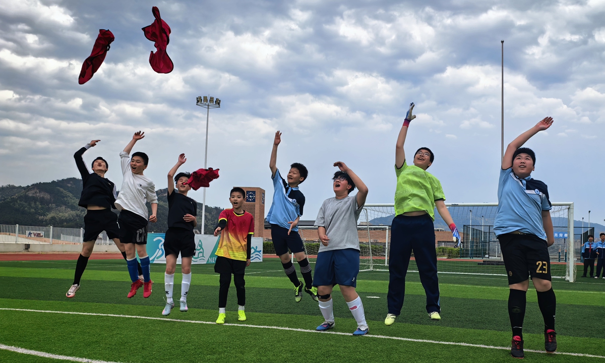 Students of Grade 7 from The Experimental School Affiliated to the Ocean University of China cheer for victory after a competition of the school's campus football tournament on May 11, 2026. Photo: Courtesy of Zhang Nianyi