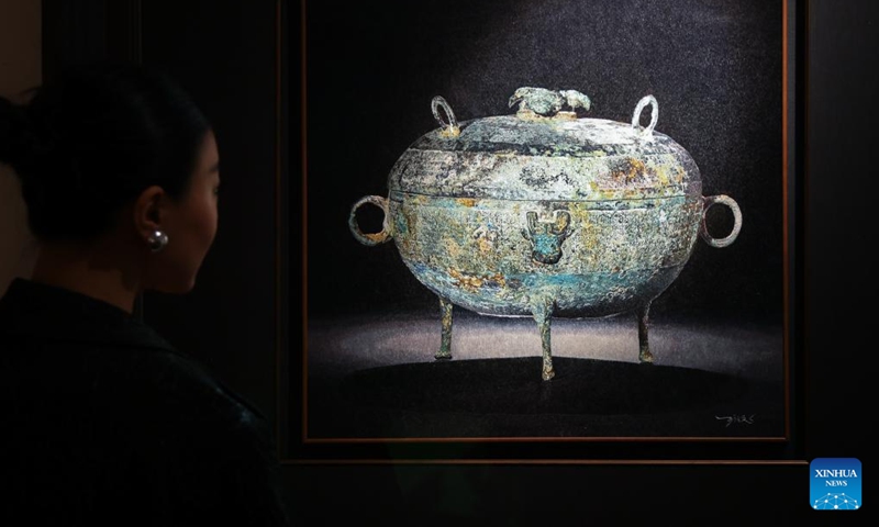 A woman looks at an artwork during London Craft Week, in central London, Britain, May 11, 2026. The event is held here from May 11 to 17. (Xinhua)

