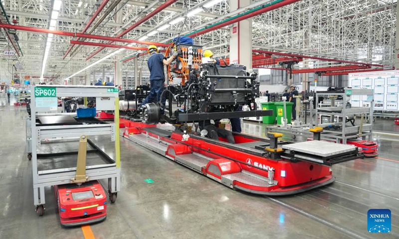 Workers work on an automated guided vehicle carrying a heavy truck chassis at an industrial park of Sany, China's leading heavy equipment manufacturer, in Changsha, central China's Hunan Province, May 12, 2026. Stepping into an intelligent heavy truck industrial park of Sany in Changsha, Hunan Province, one can see a bustling scene on the intelligent production lines.

Over a hundred welding robots operate with high precision, while more than 700 automated guided vehicles (AGVs) shuttle efficiently around the workshop.

At here, a new energy heavy truck rolls off the production line every six minutes. (Xinhua/Xue Yuge)