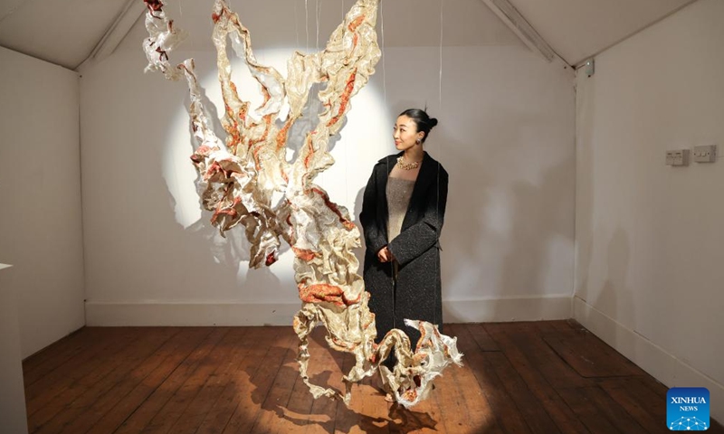 A woman looks at an artwork during London Craft Week, in central London, Britain, May 11, 2026. The event is held here from May 11 to 17. (Xinhua)

