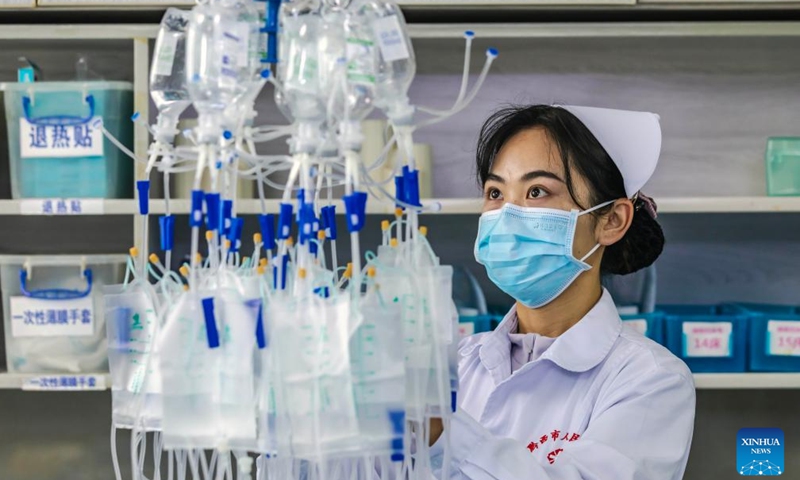 A nurse prepares medicine at a hospital in Qianxi City, southwest China's Guizhou Province, May 12, 2026. International Nurses Day falls annually on May 12. (Photo by Fan Hui/Xinhua)

