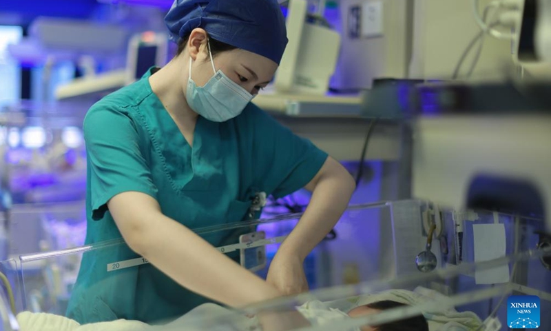 Nurse Yang Limei takes care of a neonatal patient at the neonatology department of the First People's Hospital of Yunnan Province in Kunming, southwest China's Yunnan Province, May 11, 2026. As the neonatal nurses in the First People's Hospital of Yunnan Province, Yang Limei and her colleagues' routine work is to take care of the newborns suffering with critical illness like premature birth, asphyxia, congenital diseases or severe infections.

