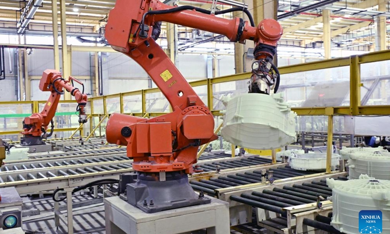 Robotic arms grab parts of washing machines on a production line at the Haier Qingdao Washing Machine Interconnected Factory in Qingdao, east China's Shandong Province, May 12, 2026. Located in the West Coast New Area of Qingdao, the factory is a full-scenario 5.5G demonstration lighthouse factory. Relying on 130 advanced technologies such as 5.5G, advanced algorithms, and digital twins, the factory has further optimized its products and services. (Xinhua/Li Ziheng)

