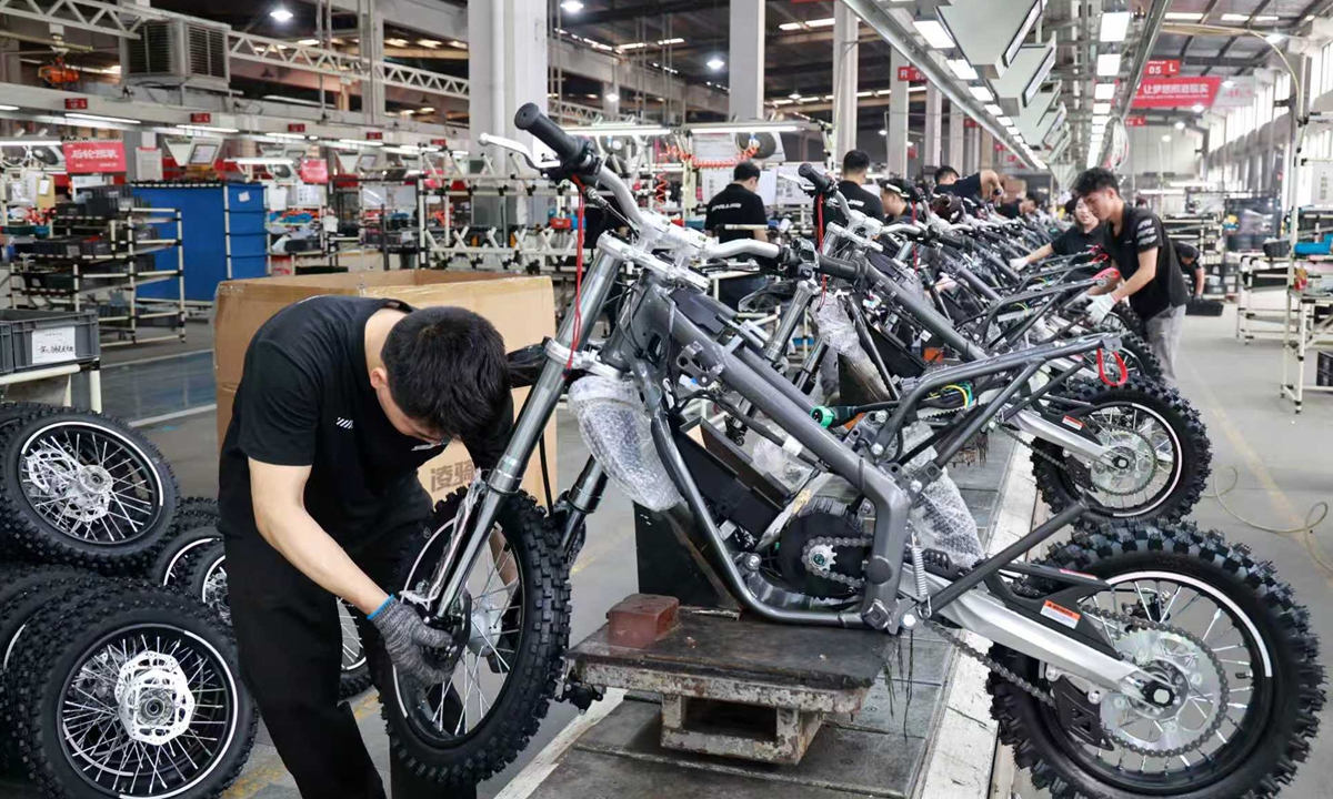 Workers make electric off-road motorcycles for export markets at a sports technology company's workshop in Jinhua, East China's Zhejiang Province, on May 13, 2026. Data from the General Administration of Customs showed that China's private enterprises' exports of electric motorcycles and bicycles rose 30 percent year-on-year in the first quarter. Photo: VCG