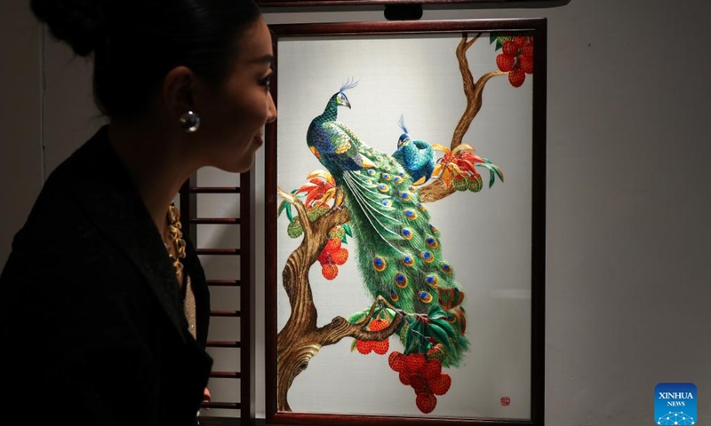 A woman looks at an artwork during London Craft Week, in central London, Britain, May 11, 2026. The event is held here from May 11 to 17. (Xinhua)

