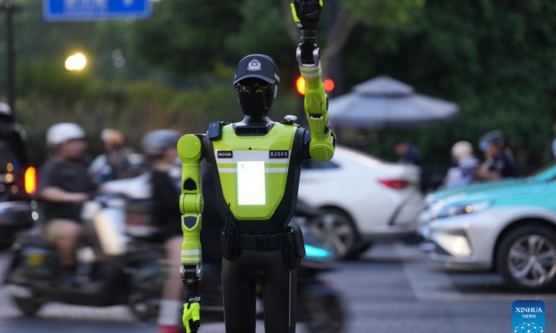 An intelligent traffic management robot is on duty at a crossroad in the Hubin business area of Hangzhou, east China's Zhejiang Province, May 11, 2026. Fifteen intelligent traffic management robots have been deployed at key intersections of the West Lake scenic area, Hubin business area, and main urban roads in Hangzhou, undertaking the tasks such as showing the way for tourists, dissuading riders of non-motorized vehicles and pedestrians from violating traffic rules, and directing the traffic. (Xinhua/Huang Zongzhi)