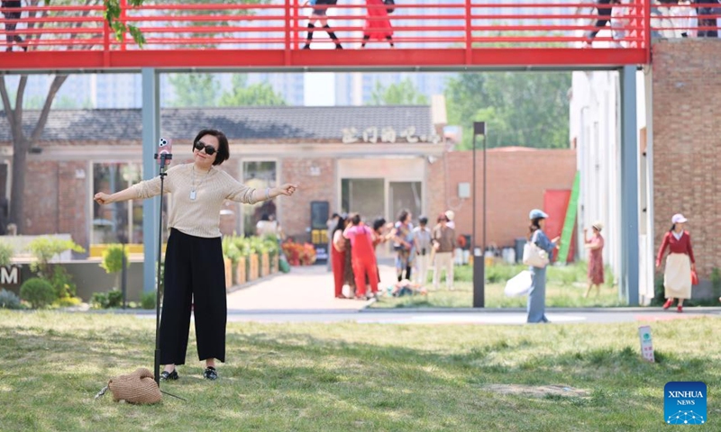 Tourists visit a tourism and leisure block in Zhongbei Town of Xiqing District in north China's Tianjin, May 10, 2026. Recently, a tourism and leisure block opened to the public in Tianjin. Covering about 45,000 square meters, the district was transformed from abandoned buildings of a yarn-dyed fabric factory. (Xinhua/Li Ran)