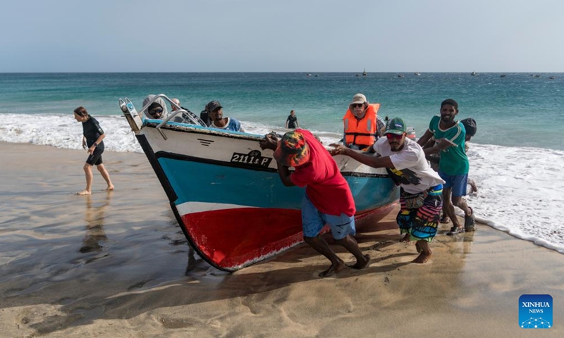 People land on the shore after a boat trip in Sao Vicente Island, Cape Verde, May 13, 2026. Sao Vicente Island is located in the northwestern part of the Cape Verde archipelago. Characterized by volcanic mountains and arid hills, the island is best known for the port city of Mindelo and has become a popular tourist destination. (Xinhua/Xie Jianfei)

