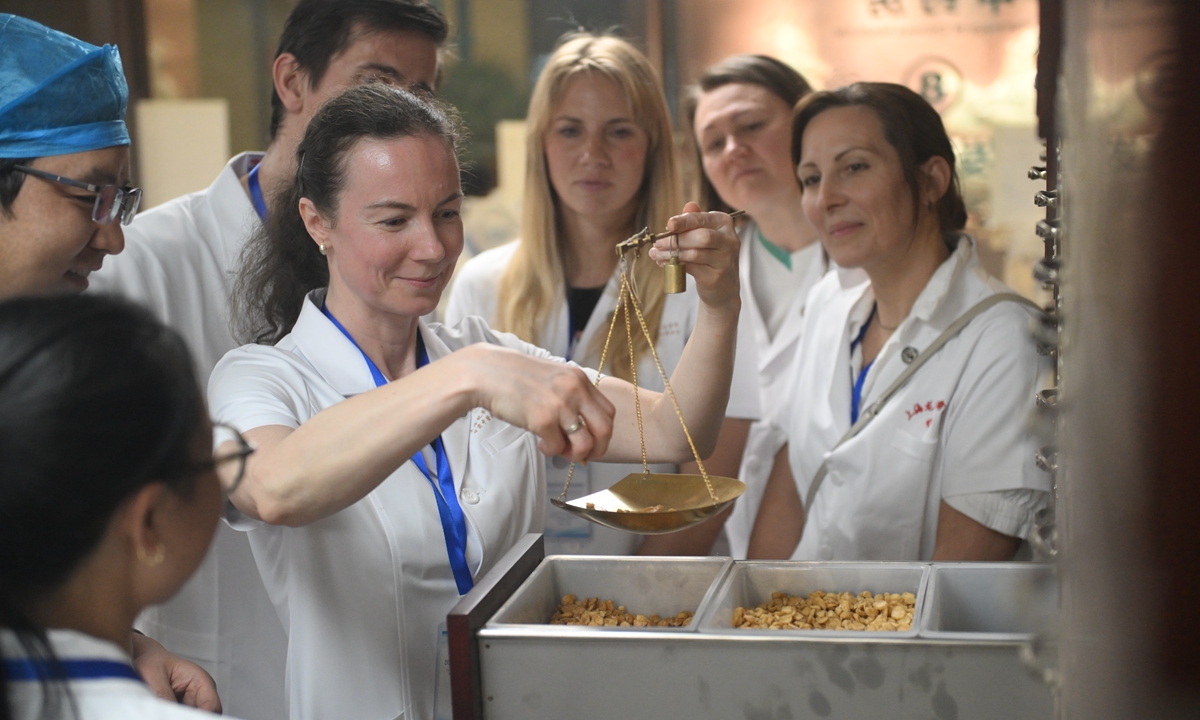 Traditional Chinese medicine (TCM) students from countries including the Czech Republic and Slovakia practice dispensing herbal medicine at a hospital in Lanzhou, Northwest China's Gansu Province, on May 14, 2026. A total of 15 European learners are in Gansu for a two-week study and practical training program in TCM. Photo: VCG