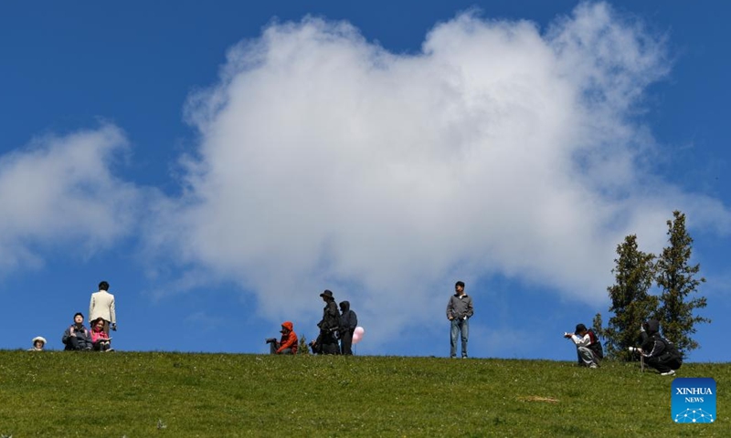 Tourists enjoy scenery at Guozigou in Huocheng County, northwest China's Xinjiang Uygur Autonomous Region, May 13, 2026. (Xinhua/Hu Huhu)

