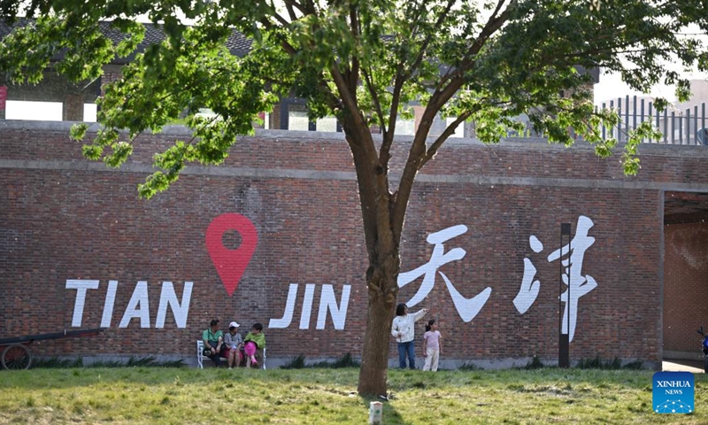 Tourists visit a tourism and leisure block in Zhongbei Town of Xiqing District in north China's Tianjin, May 12, 2026. Recently, a tourism and leisure block opened to the public in Tianjin. Covering about 45,000 square meters, the district was transformed from abandoned buildings of a yarn-dyed fabric factory. (Xinhua/Li Ran)