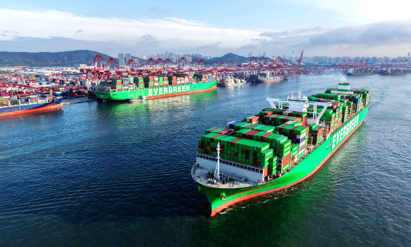 A cargo ship loaded with containers departs from the Qingdao Port on May 19, 2026, in Qingdao, East China's Shandong Province. Loading and unloading operations are proceeding in an orderly manner at the port, reflecting bustling trade. China's merchandise trade reached 16.2 trillion yuan ($2.4 trillion) from January to April, up 14.9 percent year-on-year, official data showed. Photo: VCG