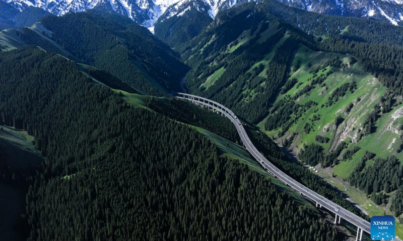 A drone photo taken on May 13, 2026 shows an expressway winding across Guozigou in Huocheng County, northwest China's Xinjiang Uygur Autonomous Region. (Xinhua/Hu Huhu)

