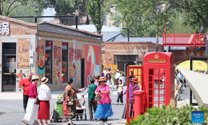 Tourists visit a tourism and leisure block in Zhongbei Town of Xiqing District in north China's Tianjin, May 10, 2026. Recently, a tourism and leisure block opened to the public in Tianjin. Covering about 45,000 square meters, the district was transformed from abandoned buildings of a yarn-dyed fabric factory. (Xinhua/Li Ran)