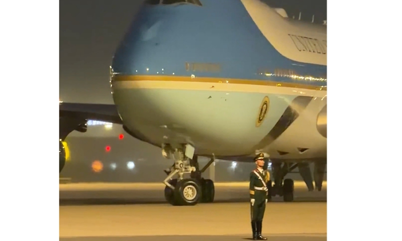 A screenshot from a video posted by Jon Michael Raasch, White House correspondent for the Daily Mail, shows a Chinese People's Liberation Army soldier standing motionless beside the runway as US President's Air Force One taxis behind him at Beijing Capital International Airport.