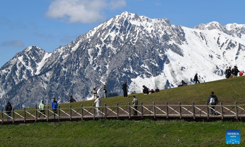 Tourists enjoy scenery at Guozigou in Huocheng County, northwest China's Xinjiang Uygur Autonomous Region, May 13, 2026. (Xinhua/Hu Huhu)

