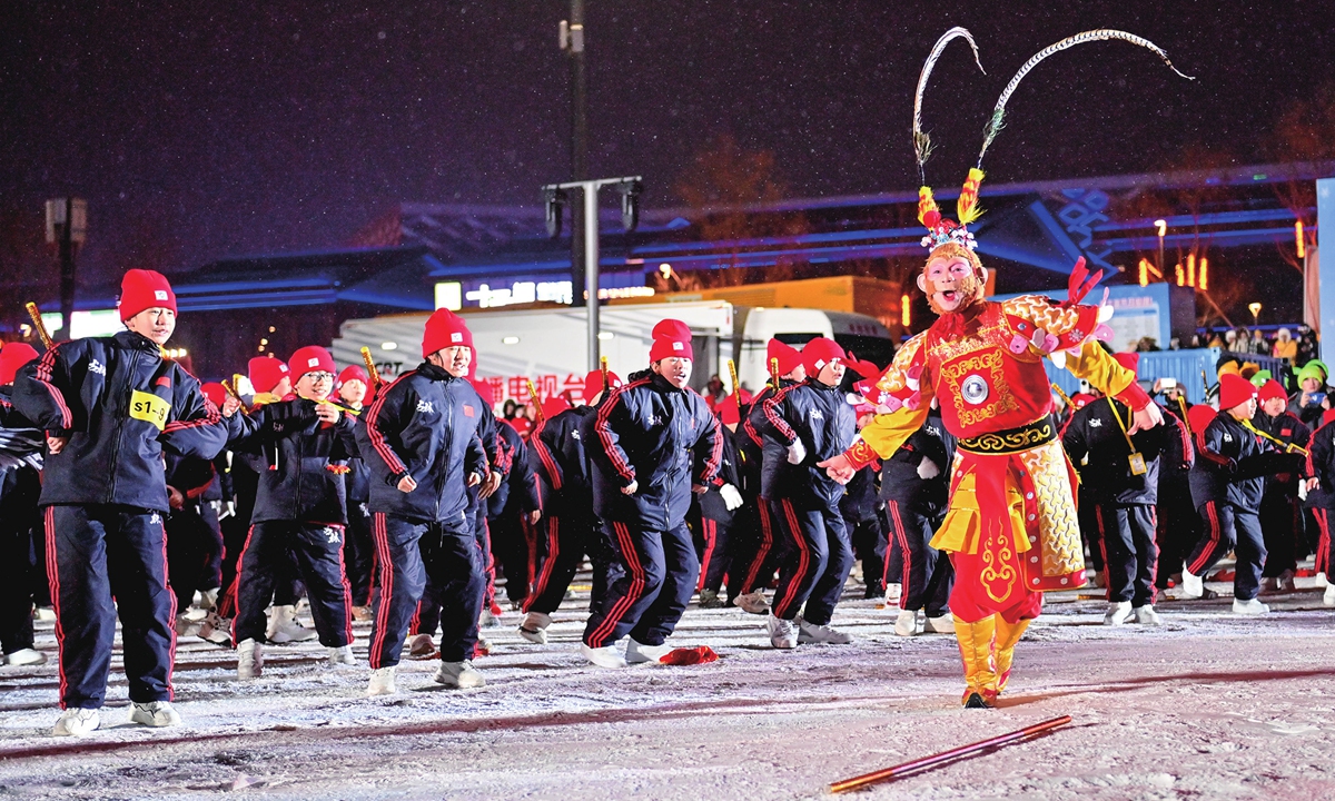 The popular Xuebing Monkey dances with students in the snow during the opening ceremony of China's 12th National Public Ice and Snow Season in Changchun, Northeast China's Jilin Province, on January 6, 2026. Photo: VCG