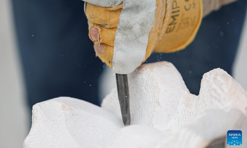 A craftsman works on a marble sculpture at a workshop in Pietrasanta, Italy, May 13, 2026. Pietrasanta has long served as a center for marble sculpture processing in Italy. In recent years, the town's marble workshops have introduced digital technologies to improve the efficiency and quality of their works. (Xinhua/Wang Kaiyan)
