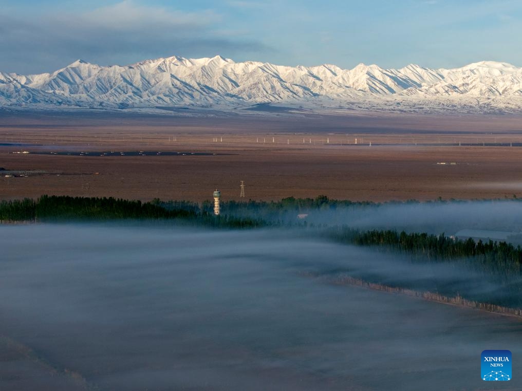 An aerial drone photo taken on May 14, 2026 shows the Altun Mountains and a village in the Kazak Autonomous County of Aksay, northwest China's Gansu Province. (Photo by Gao Hongshan/Xinhua)

