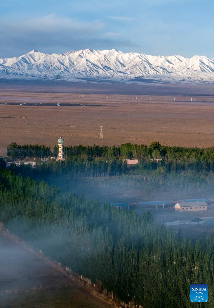 An aerial drone photo taken on May 14, 2026 shows the Altun Mountains and a village in the Kazak Autonomous County of Aksay, northwest China's Gansu Province. (Photo by Gao Hongshan/Xinhua)

