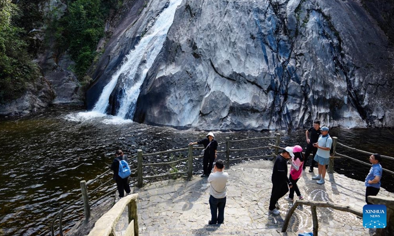 Tourists visit the Biaoshuiyan waterfall in Jinping Miao, Yao and Dai Autonomous County, southwest China's Yunnan Province, May 14, 2026. In early summer, the waterfall clusters in Jinping attracted many tourists. (Xinhua/Chen Xinbo)