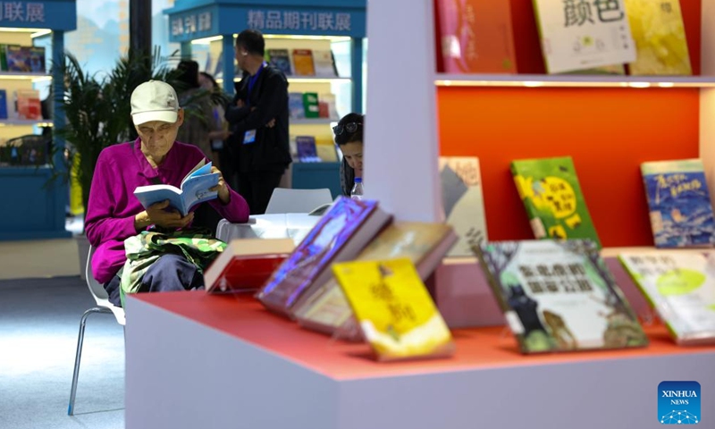 A visitor reads during the third Northeast China Book Fair in Changchun, northeast China's Jilin Province, May 14, 2026. (Xinhua/Yan Linyun)

