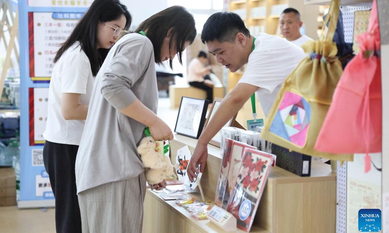 Visitors select cultural and creative products during the third Northeast China Book Fair in Changchun, northeast China's Jilin Province, May 14, 2026. (Xinhua/Yan Linyun)

