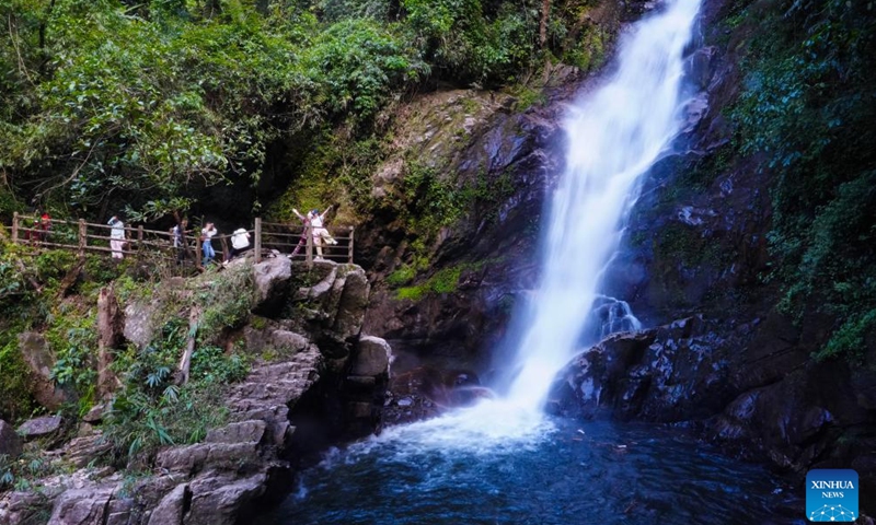Tourists visit the Ladeng waterfall scenic area in Jinping Miao, Yao and Dai Autonomous County, southwest China's Yunnan Province, May 13, 2026. In early summer, the waterfall clusters in Jinping attracted many tourists. (Xinhua/Chen Xinbo)