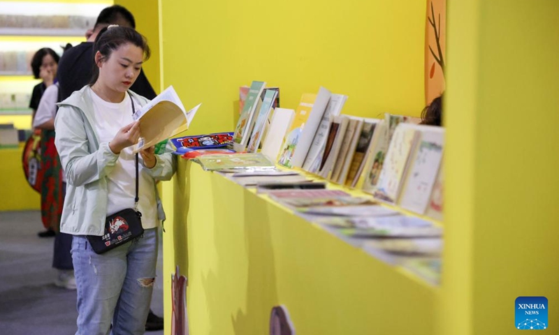 A visitor reads during the third Northeast China Book Fair in Changchun, northeast China's Jilin Province, May 14, 2026. (Xinhua/Yan Linyun)

