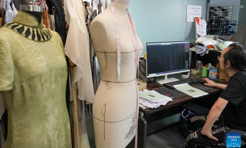 A staff member develops garment templates with a computer at Chenfeng Fashion Creative Industrial Park in Kunshan City, east China's Jiangsu Province, May 13, 2026. Backed by leading textile and garment enterprises in the country, Kunshan has launched the Chenfeng Fashion Creative Industrial Park, which is now home to nearly 150 businesses in the fashion arena. Over 30 emerging brands have been incubated there. (Xinhua/Li Bo)

