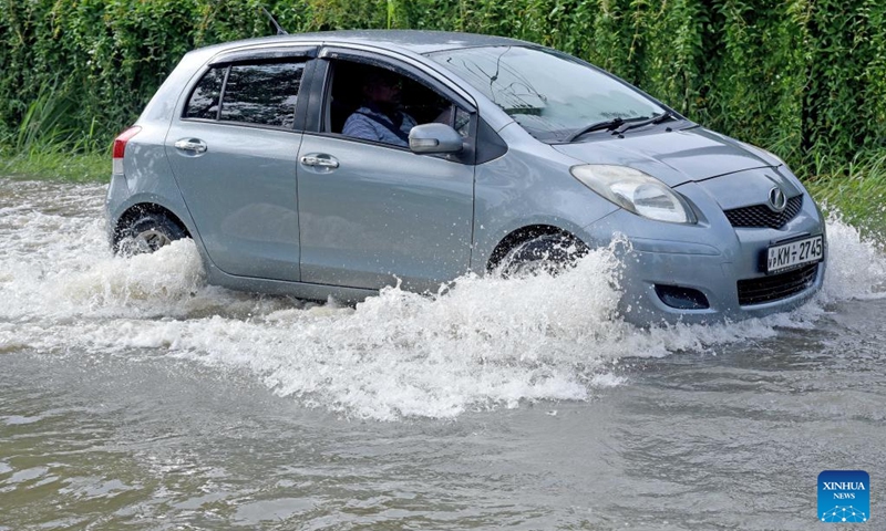 A car moves on a flooded road after heavy rains in Gampaha, Sri Lanka, May 15, 2026. A persistent low-pressure area has brought cloudy skies and widespread showers across several provinces in the country. (Photo: Xinhua)