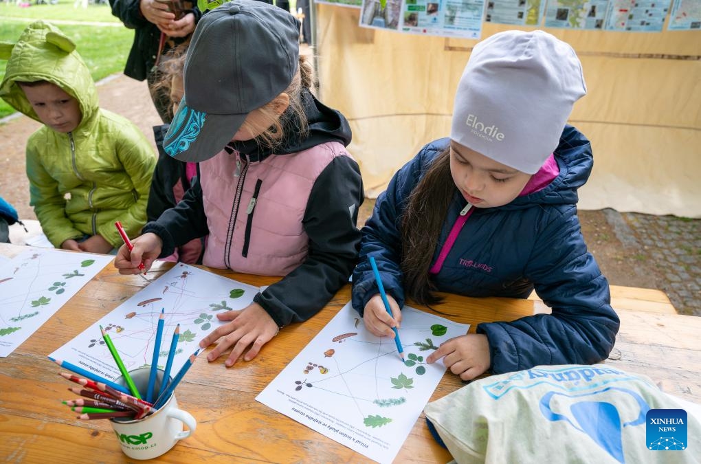 Girls work on an educational worksheet during an Earth Day-themed event in Prague, the Czech Republic, May 14, 2026. The event was held in Prague on Thursday, featuring educational games, workshops, and presentations. (Photo: Xinhua)