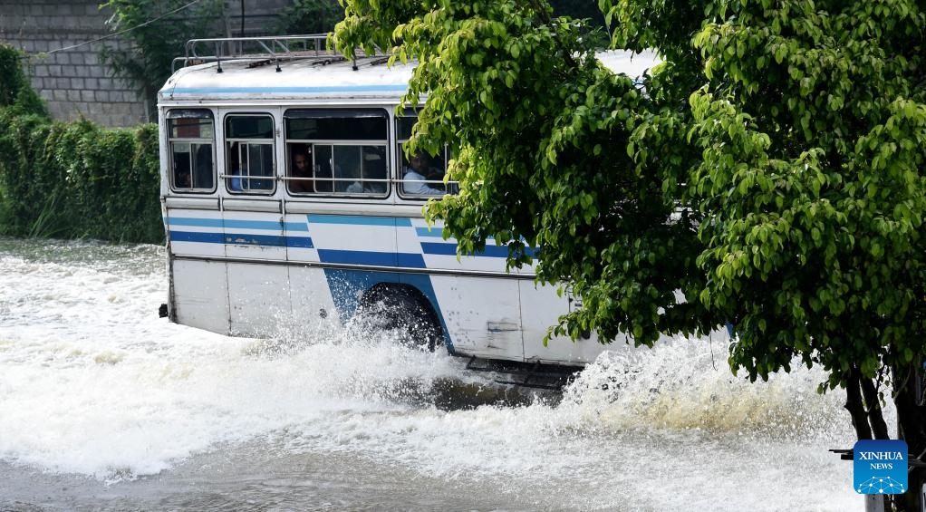A bus moves on a flooded road after heavy rains in Gampaha, Sri Lanka, May 15, 2026. A persistent low-pressure area has brought cloudy skies and widespread showers across several provinces in the country. (Photo: Xinhua)