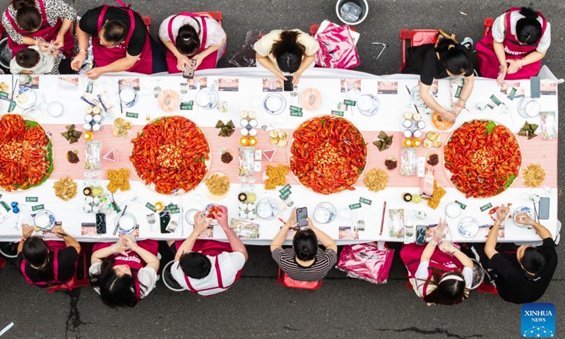 A drone photo taken on May 15, 2026 shows visitors enjoying themselves during a grand crayfish banquet in Nanxian County, Yiyang City of central China's Hunan Province. A grand crayfish banquet was held here on Friday. Nanxian County boasts a total arable land area of 630,000 mu (about 42,000 hectares) for shared paddy rice planting and crayfish cultivation, which is now a pillar business for rural revitalization in the county. (Photo: Xinhua)