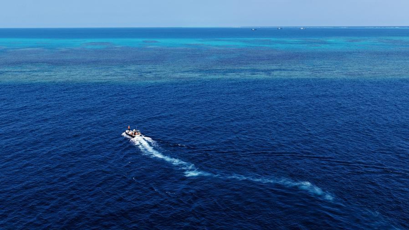 An aerial drone photo taken on May 2, 2026 shows a boat deployed by the China Coast Guard (CCG) vessel Chuanshan patrolling around reefs in the territorial waters of China's Huangyan Dao in the South China Sea. (Xinhua/Chen Bin)