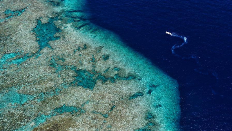 An aerial drone photo taken on April 28, 2026 shows a boat deployed by the China Coast Guard (CCG) vessel Chuanshan patrolling near a reef in the territorial waters of China's Huangyan Dao in the South China Sea. (Xinhua/Chen Bin)