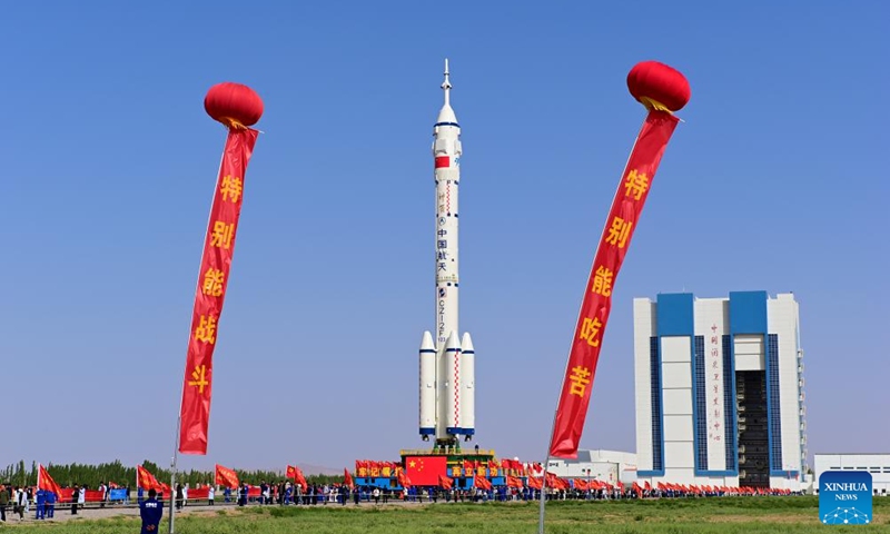This photo taken on May 16, 2026 shows the combination of the Shenzhou-23 crewed spaceship and a Long March-2F carrier rocket being transferred to the launching area. (Photo by Wang Jiangbo/Xinhua)
